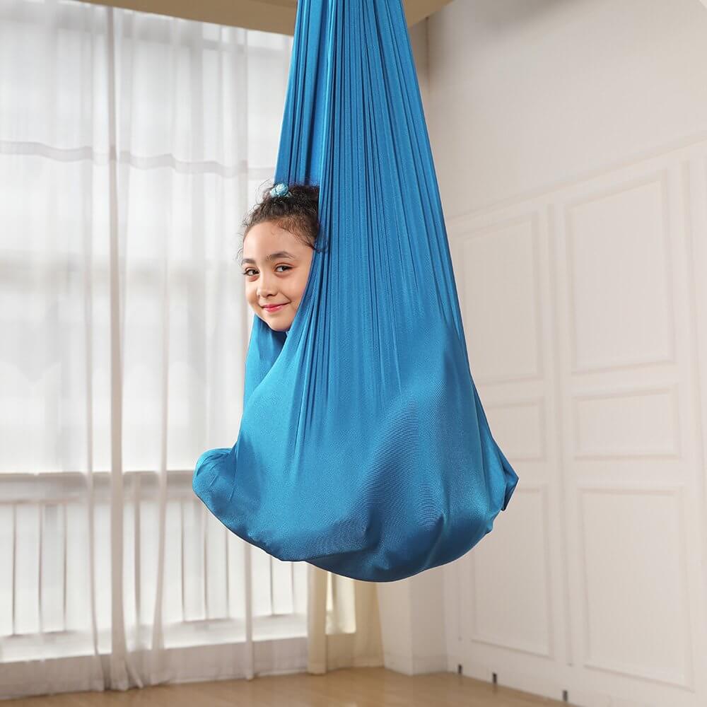 Kids Elastic Yoga Sensory Hammock Swing with a child sitting inside it.