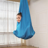 Kids Elastic Yoga Sensory Hammock Swing with a child sitting inside it.