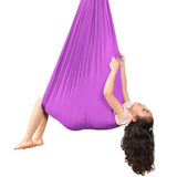 Kids Elastic Yoga Sensory Hammock Swing with a child sitting inside it.