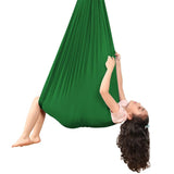 Kids Elastic Yoga Sensory Hammock Swing with a child sitting inside it.