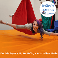 Professional therapy swing from TherapySensory.com.au shows a woman laying in a red swing.
