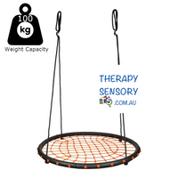 Spider web nest swing from TherapySensory.com.au displayed. Swing has a padded outer edge with orange rope in the middle in a cobweb design to support the swinger. Swing can support up to 100kg.