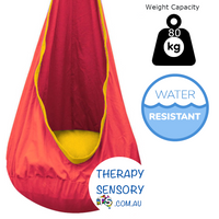 Waterproof Outdoor Sensory Swing Pod from TherapySensory.com.au displays a red swing.